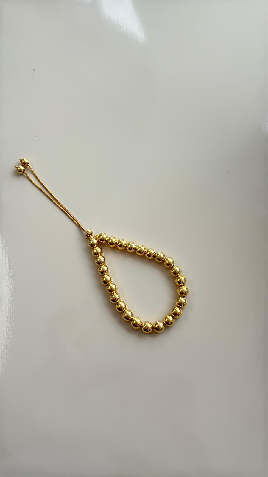 pulseira de bolas douradas com fecho de gravatinha