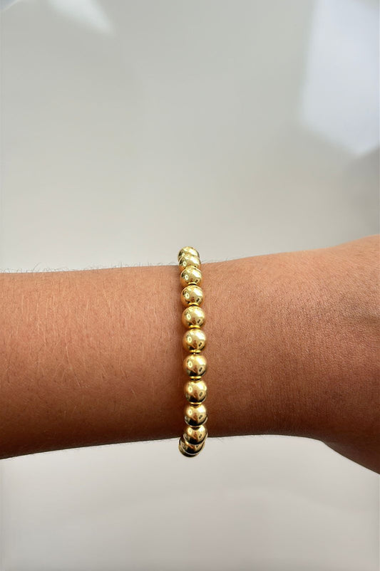 pulseira de bolas douradas com fecho de gravatinha