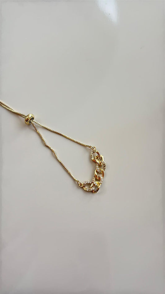 pulseira estilo bolo tie dourada com elos brilhosos