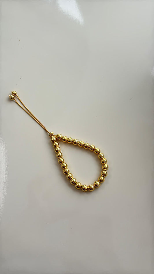 pulseira de bolas douradas com fecho de gravatinha